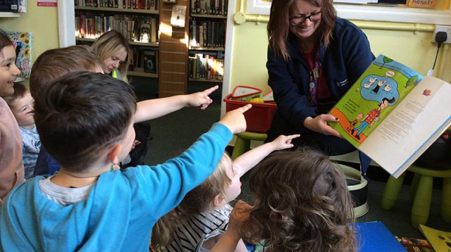 Library-children-pointing-at-book