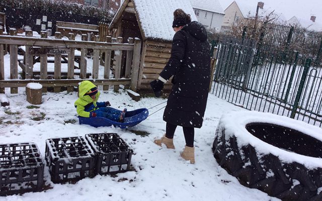 green-boy-in-snow-with-black-woman